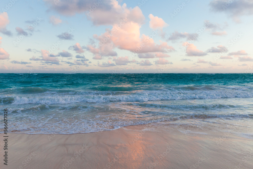 Coastal landscape with an empty sandy beach and shore waves