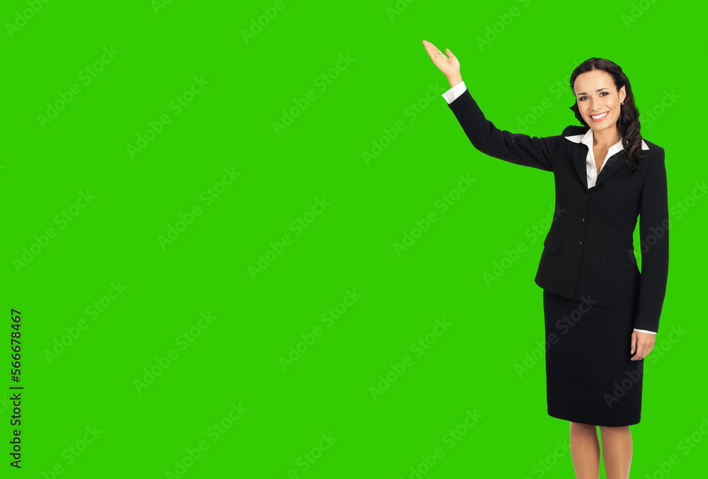 Full body of happy smiling attractive woman in black confident suit, showing copy space. Business concept. Brunette businesswoman. Green chroma key background. Full body of happy smiling attractive woman in black confident suit, showing copy space. Business concept. Brunette businesswoman. Green chroma key background.