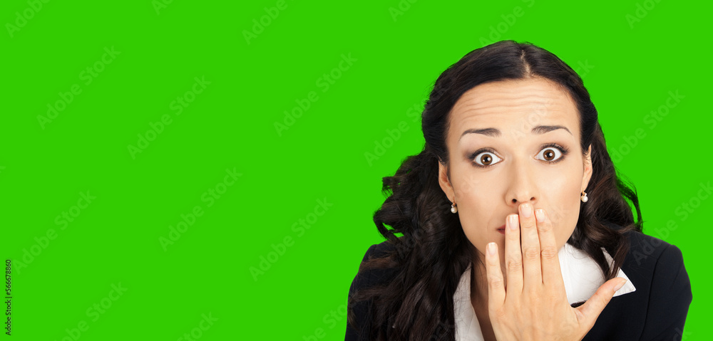 Portrait of happy smiling young business woman covering with hand her mouth. Green chroma key background. Portrait of happy smiling young business woman covering with hand her mouth. Green chroma key background.