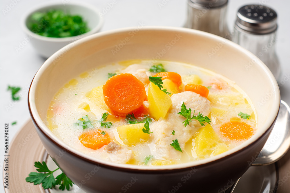 Creamy fish chowder soup in bowl on concrete background Creamy fish chowder soup in bowl on concrete background