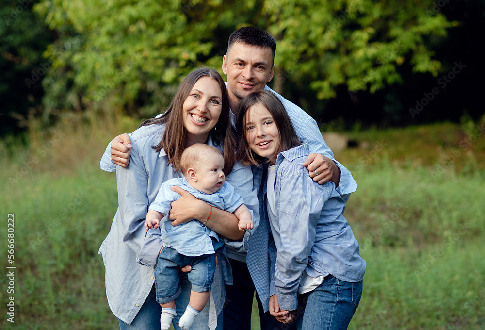 friendly family kid dream concept. lifestyle family walking in the park on the grass at sunset. friendly family kid dream concept. lifestyle family walking in the park on the grass at sunset.