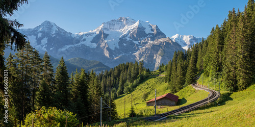 The Jungfrau paek in Bernese alps with the railway over the alps meadows.