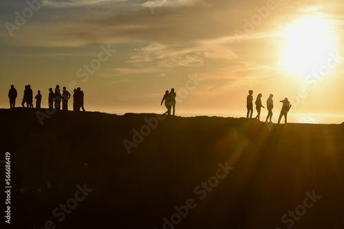 People on Cliff at Sunset