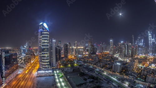 Dubai s business bay towers aerial all night . Rooftop view of some skyscrapers