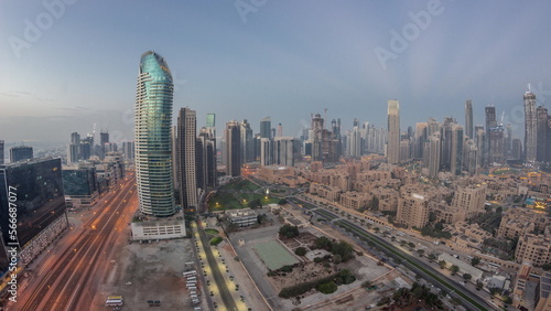 Dubai's business bay towers aerial night to day . Rooftop view of some skyscrapers © neiezhmakov