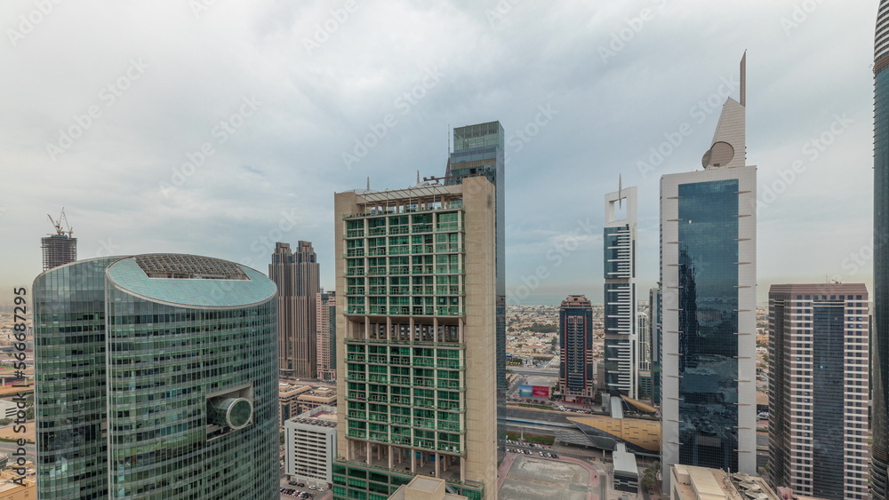 Panorama showing Dubai international financial center skyscrapers with promenade on a gate avenue aerial .