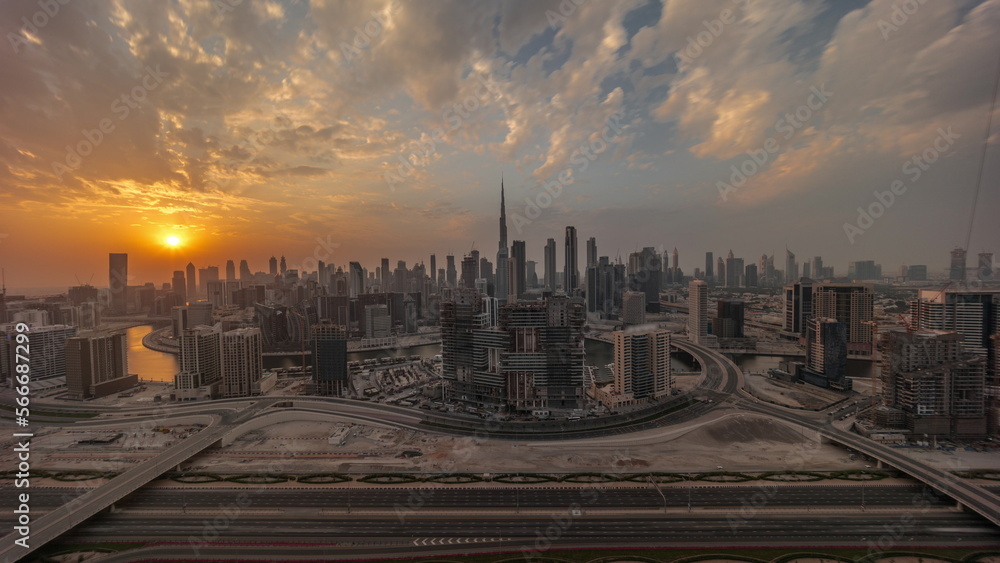 Sunset over panoramic skyline of Dubai with business bay and downtown district .