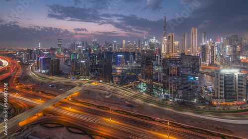 Skyline with modern architecture of Dubai business bay towers day to night . Aerial view