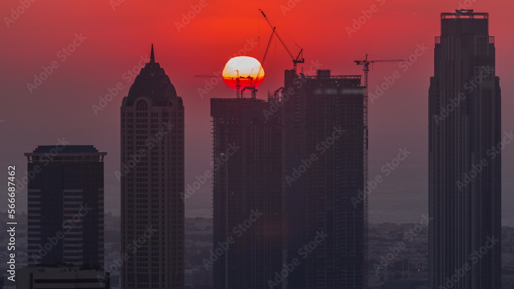 Skyline with modern architecture of Dubai business bay towers at sunset . Aerial view