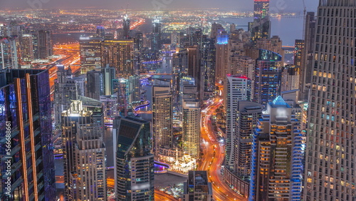 Skyline panoramic view of Dubai Marina showing canal surrounded by skyscrapers along shoreline day to night . DUBAI, UAE