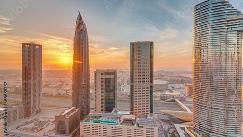 Sky view to skyscrapers during sunset in Dubai downtown aerial .