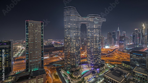 Panorama showing futuristic Dubai Downtown and finansial district skyline aerial night .