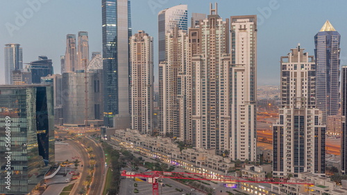 Bay Avenue with modern towers residential development in Business Bay aerial night to day , Dubai
