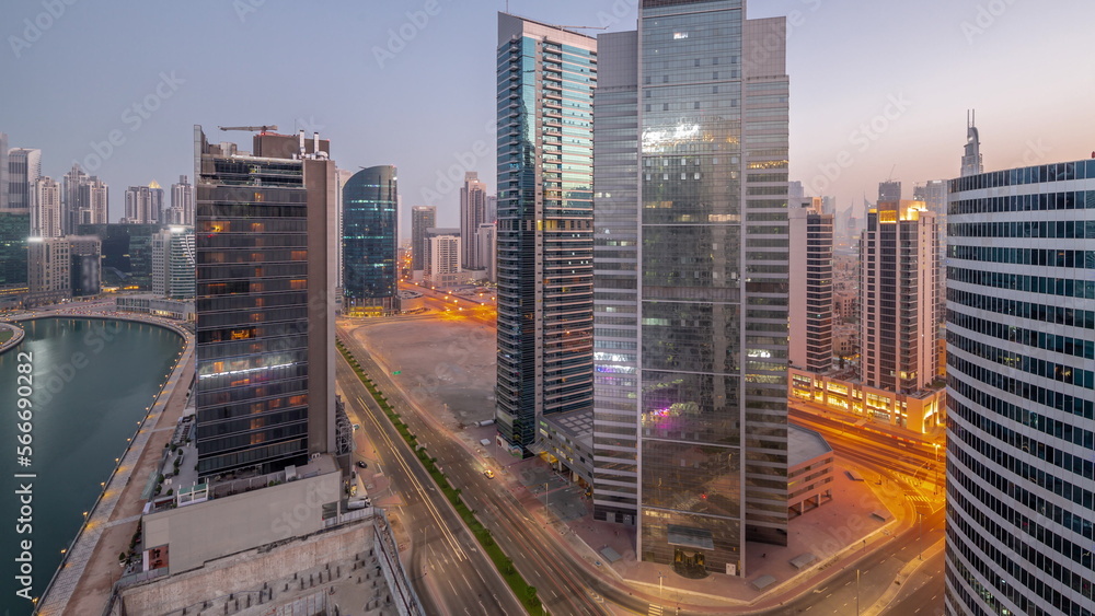 Obraz premium Cityscape of skyscrapers in Dubai Business Bay with water canal aerial night to day