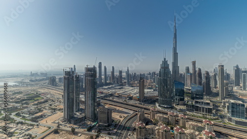 Panorama showing aerial view of tallest towers in Dubai Downtown skyline and highway .