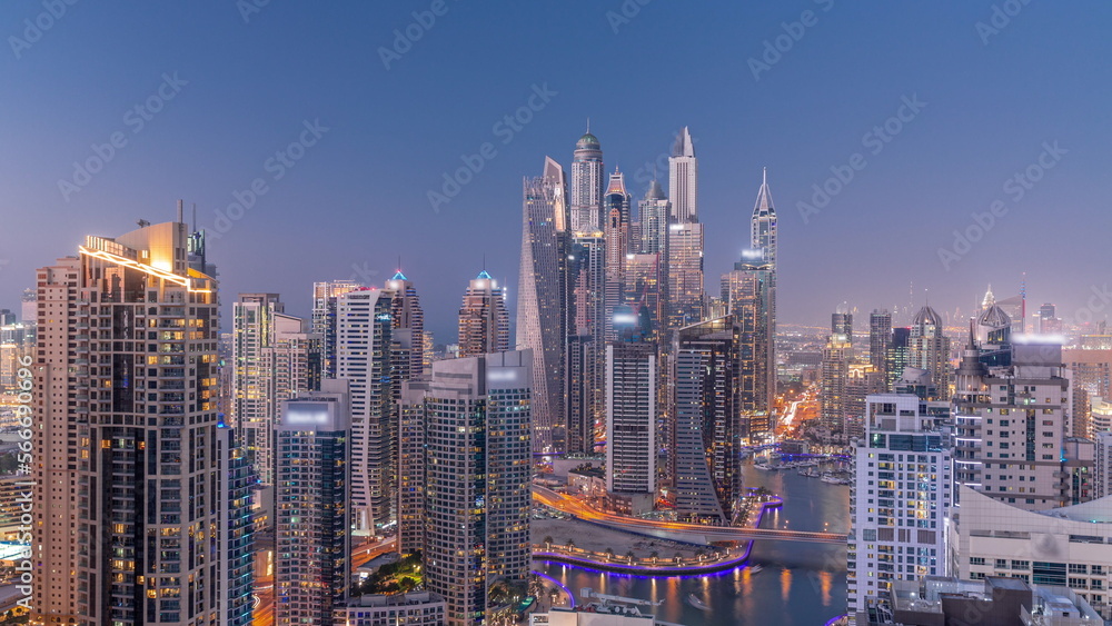 View of various skyscrapers in tallest recidential block in Dubai Marina aerial day to night