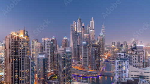 View of various skyscrapers in tallest recidential block in Dubai Marina aerial day to night