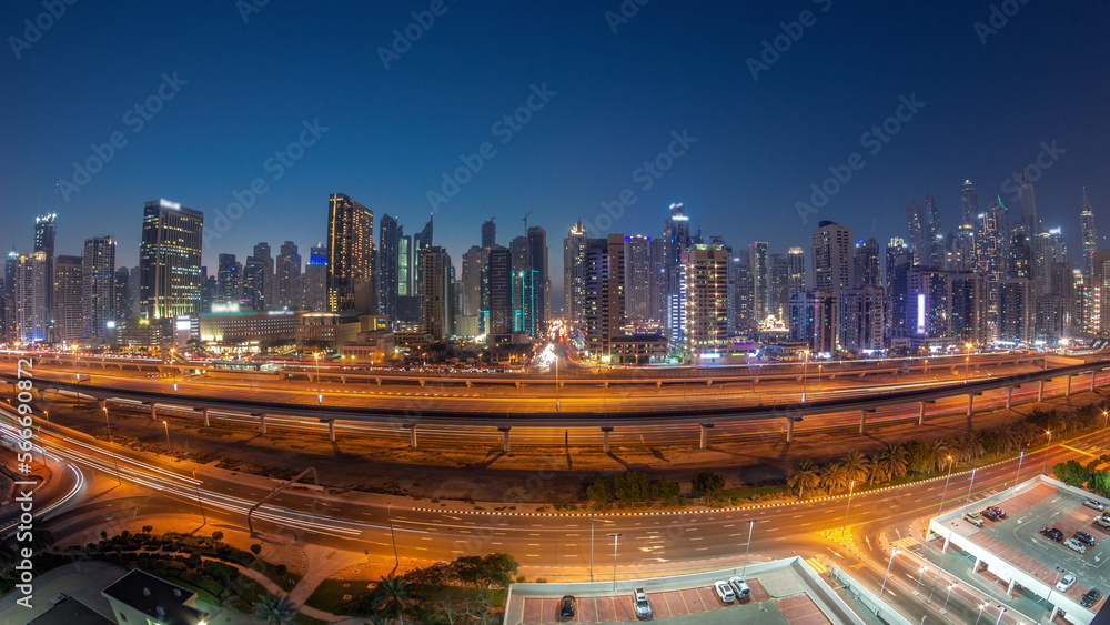 Fototapeta premium Panorama of Dubai Marina skyscrapers and Sheikh Zayed road with metro railway aerial day to night , United Arab Emirates