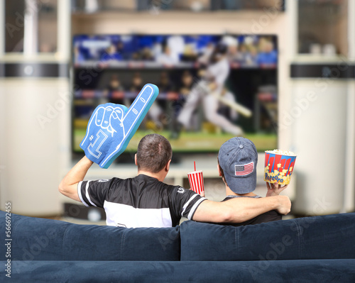 Fans of the baseball. Father and son watching TV. USA photo