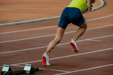 athlete running from start of sprint race