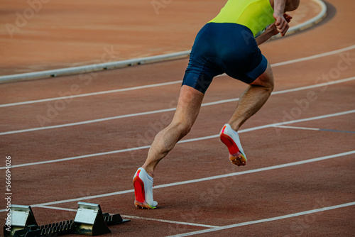 athlete running from start of sprint race
