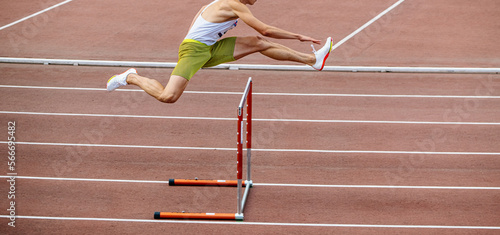 Photos male athlete running 400 meters hurdles at stadium