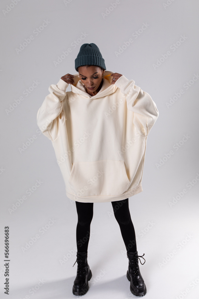 Attractive african american woman in oversized white hoodie. Mock-up. Attractive african american woman in oversized white hoodie. Mock-up.