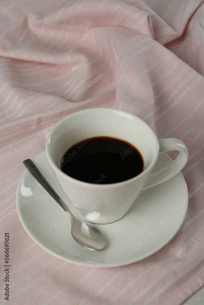 Obraz premium Cup of aromatic coffee on white wooden table