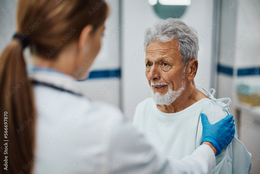 Worried senior man getting comforted by doctor at medical clinic. Worried senior man getting comforted by doctor at medical clinic.