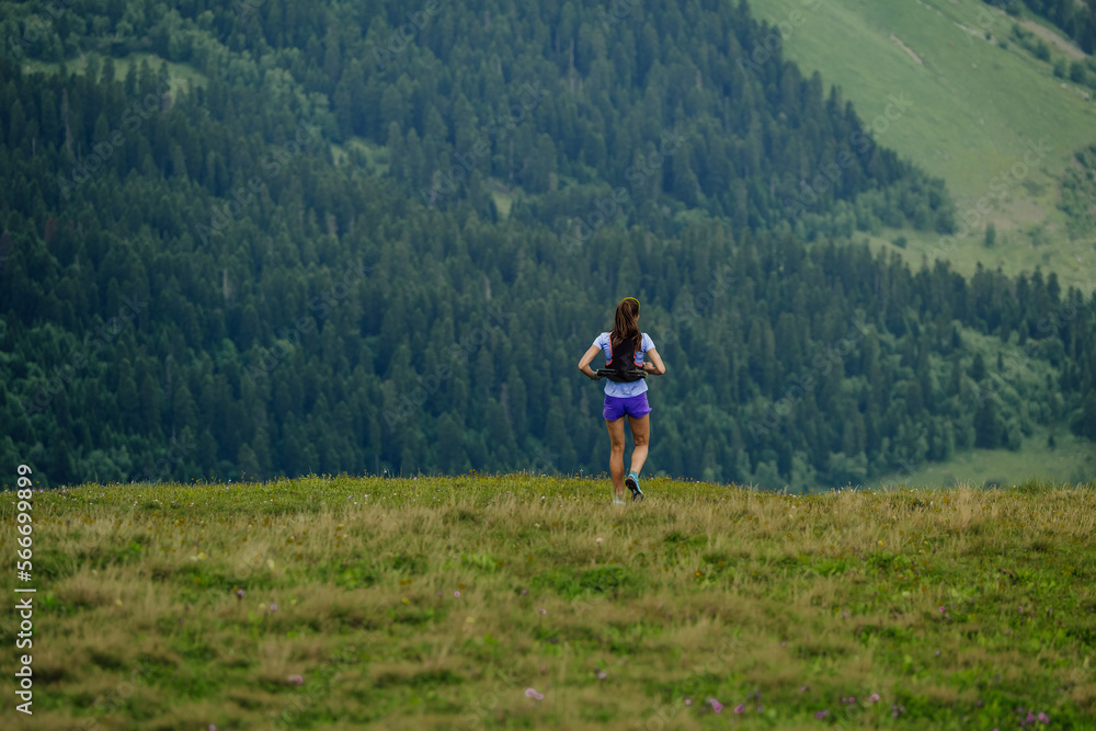 female trail runner running ultramarathon race female trail runner running ultramarathon race