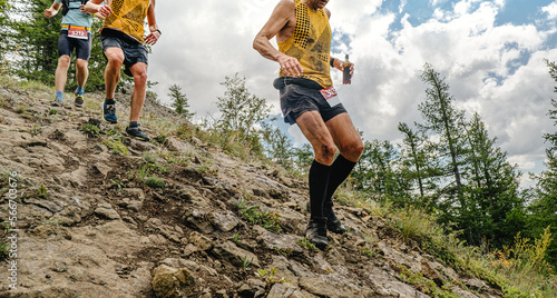group athletes running mountain trail race