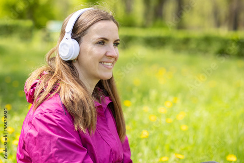Beautiful young woman likes to listen to music with headphones
