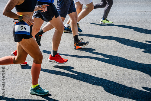 legs group runners run marathon race on road