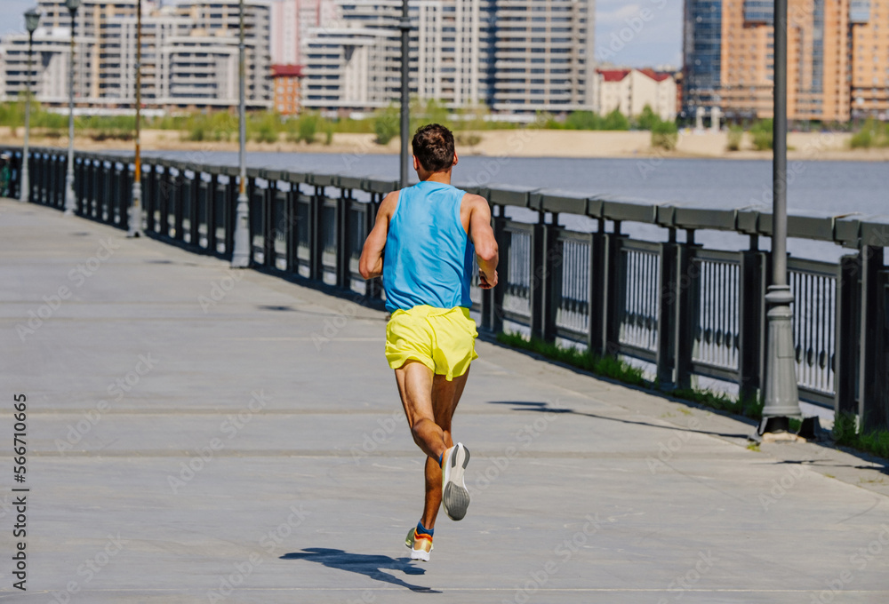 back male runner run marathon in riverfront back male runner run marathon in riverfront