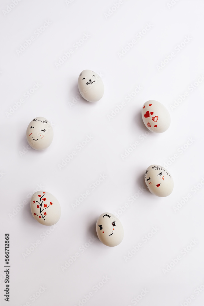 Beautifully painted Easter eggs are placed in a circle on white background. Minimal concept. Easter card with copy space for text. Flat lay style. Beautifully painted Easter eggs are placed in a circle on white background. Minimal concept. Easter card with copy space for text. Flat lay style.