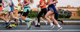 group male and female runners run city race