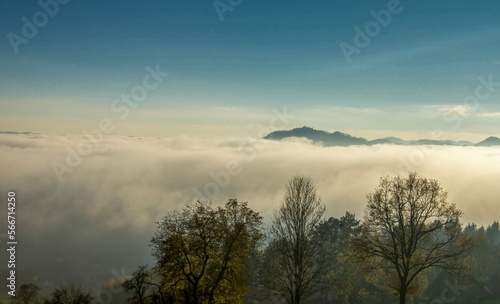 Heavy fog and mist surrounds forested mountain peaks  © Peter