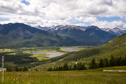 Rocky mountains in summer - a wonderful day, summer, cloudy with clearings. green meadows, coniferous forest, and lakes.