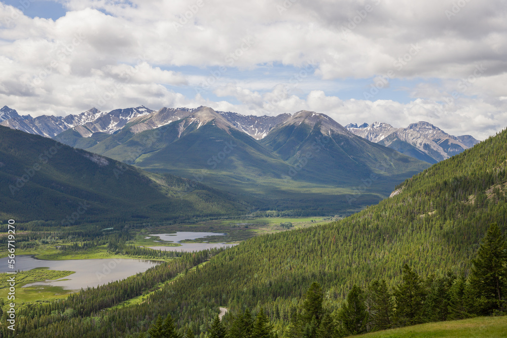 Rocky mountains in summer - a wonderful day, summer, cloudy with clearings. green meadows, coniferous forest, and lakes.