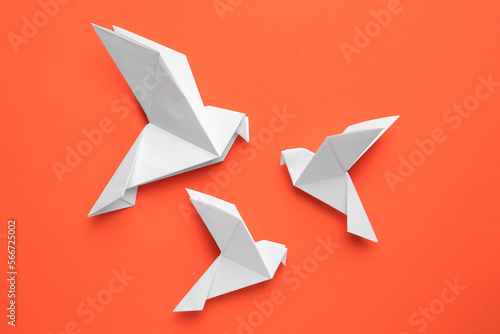 Free Download Beautiful white origami birds on orange background, flat lay - GFXLoad