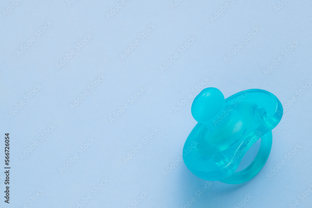 One new baby pacifier on light blue background, top view. Space for text One new baby pacifier on light blue background, top view. Space for text