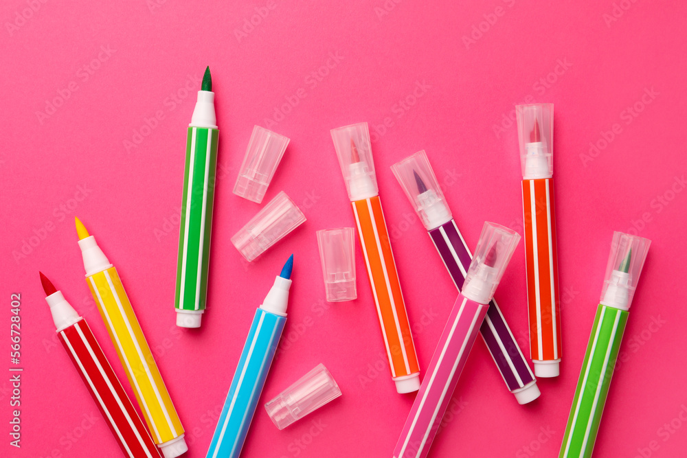 Many bright markers on pink background, flat lay Many bright markers on pink background, flat lay