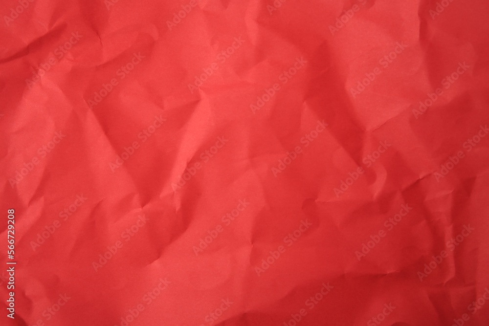 Sheet of crumpled red paper as background, top view Sheet of crumpled red paper as background, top view