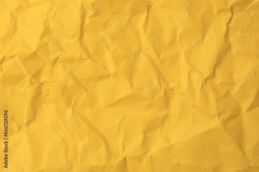 Sheet of crumpled orange paper as background, top view Sheet of crumpled orange paper as background, top view
