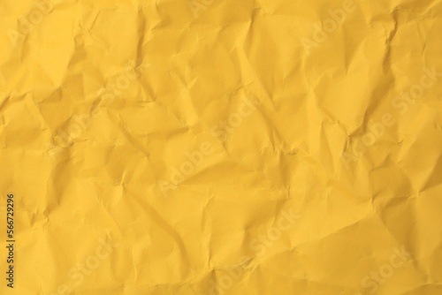 Sheet of crumpled orange paper as background, top view