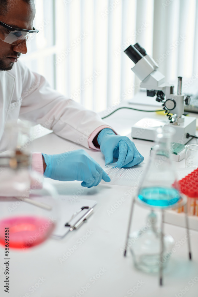 Fototapeta premium Laboratory worker checking blood of patient for diseases and viruses