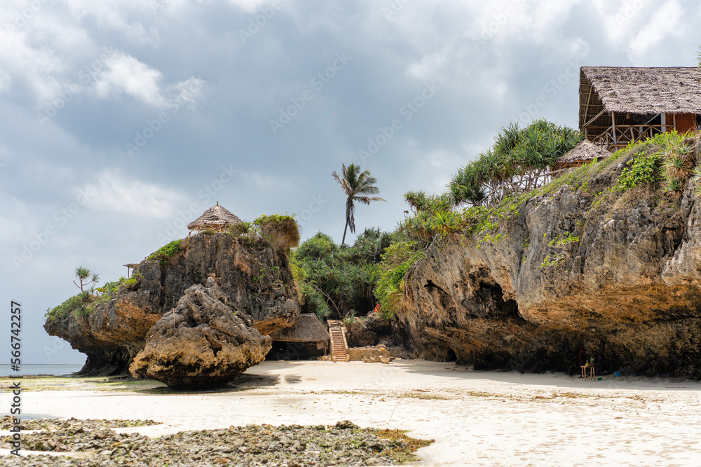 Landscape of the Indian Ocean coastline with at Mtende Beach, Zanzibar. Rocks and white sand. View from the sea