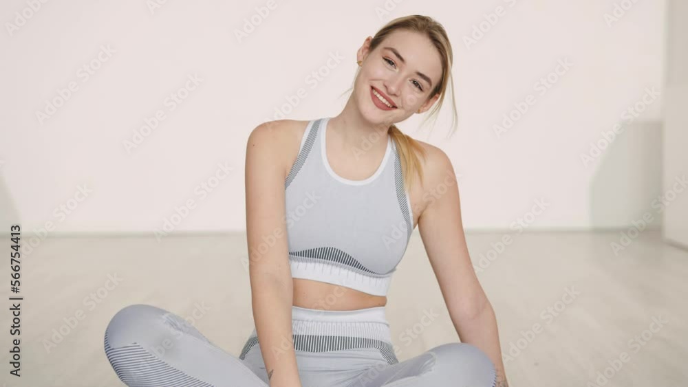 Cheerful female athlete resting during workout Cheerful female athlete resting during workout