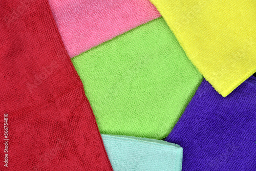 Multicolored towels laid on top of each other. Colored terry towels. Background of multicolored rags.
