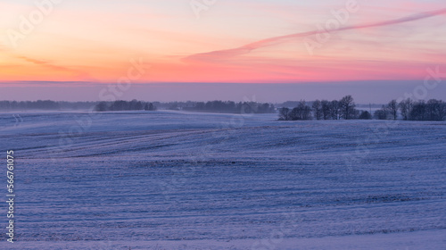 sunny, snowy winter day in the countryside at sunset